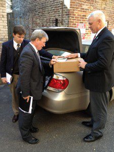 Three men praying over a case of The Purity War books in Washington across the street from the Supreme Court with Focus On the Family VP Tim Goeglein. 